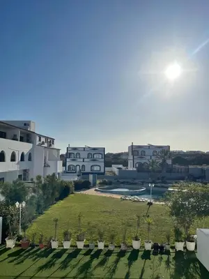 a view of a building with a yard with plants at Apartamento Don Tenório com piscina Sagres in Sagres