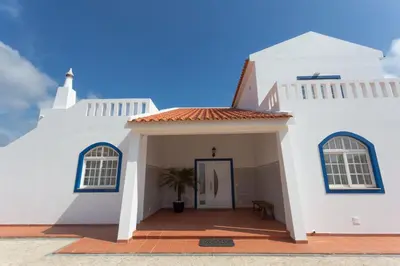 a white church with a door and a sky at Casa da praia in Carrapateira
