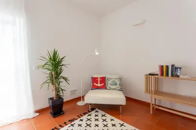 a living room with a chair and a table at Casa da praia in Carrapateira