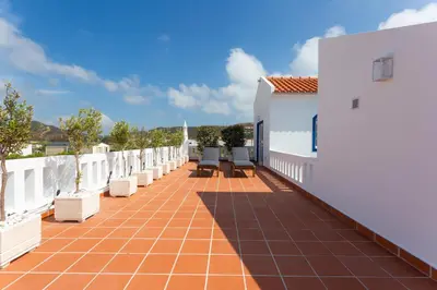 a balcony of a house with chairs on it at Casa da praia in Carrapateira