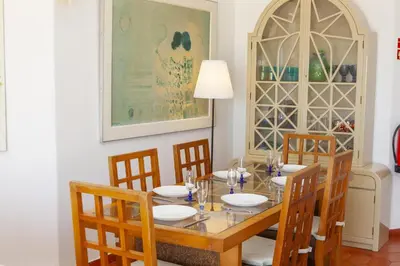 a dining room with a table and four chairs at C22 - Beco do Poço Beach Townhouse in Praia da Luz in Luz