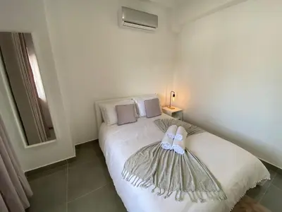 a bedroom with a bed with a dress on it at Casa com terraço e piscina Sagres in Sagres