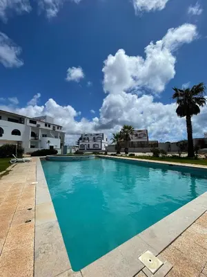 a large swimming pool in front of a building at Casa com terraço e piscina Sagres in Sagres