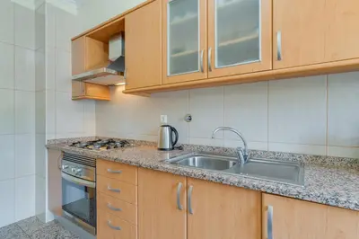 a kitchen with a sink and a stove at Sunset Horizon by Atlantic Holiday in Estreito de Câmara de Lobos