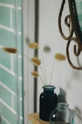 a blue vase sitting on a table next to a door at Little Bispo Apartments in Vila do Bispo