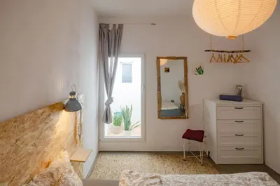 a bedroom with a bed and a dresser and a mirror at Little Bispo Apartments in Vila do Bispo