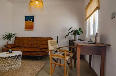 a living room with a couch and a chair at Little Bispo Apartments in Vila do Bispo