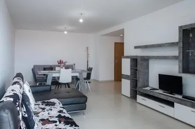 a living room with a couch and a fireplace at GuestReady - Paradisus Residence Atlantic Retreat in Caniço