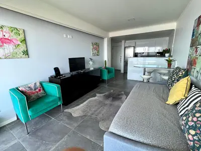 a living room with a couch and a table at Lido Sol 318 in Funchal