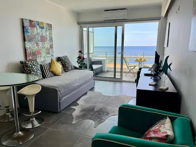 a living room with a couch and a view of the ocean at Lido Sol 318 in Funchal