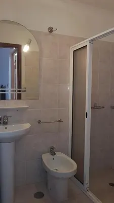 a bathroom with a sink and a toilet and a shower at Casa Luciana in Ponta do Pargo