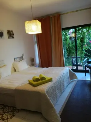 a bedroom with a bed with two yellow towels on it at Sea to see - sea front view in Caniço
