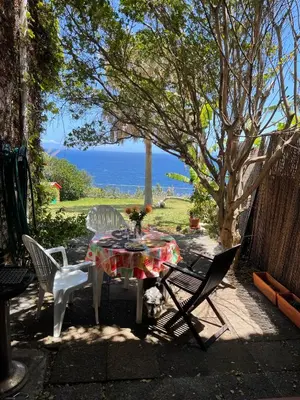 a table and chairs with a view of the ocean at Sea to see - sea front view in Caniço