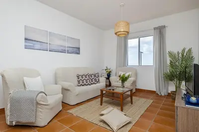 a living room with two chairs and a table at Villa Bella Mar by Homie in Porto Santo