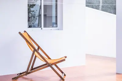 a wooden chair in a room with a window at Villa Bella Mar by Homie in Porto Santo