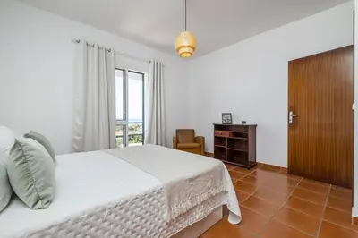 a white bedroom with a bed and a window at Villa Bella Mar by Homie in Porto Santo
