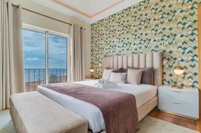 a house with a view of the ocean at Villa Gasparini Palheiro Village by Holiday Rental Madeira in Funchal
