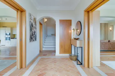 a bedroom with a large bed with a large window at Villa Gasparini Palheiro Village by Holiday Rental Madeira in Funchal