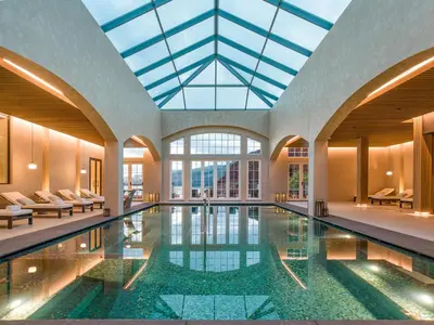 a pool in a building with a glass ceiling at Dreams Madeira Resort Spa & Marina in Caniçal