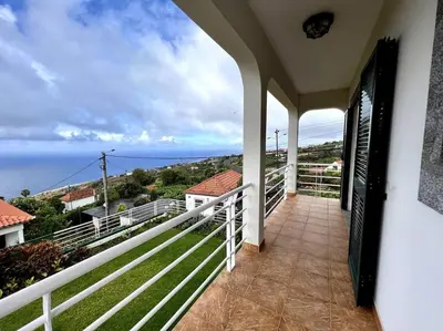 a balcony with a view of the ocean at Casa Darcey by Your Madeira Rentals in Estreito da Calheta