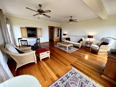 a living room filled with furniture and a hard wood floor at Casa Darcey by Your Madeira Rentals in Estreito da Calheta