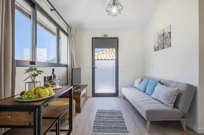 a living room with a couch and a table at Basalt Dwelling I by Homie in São Vicente