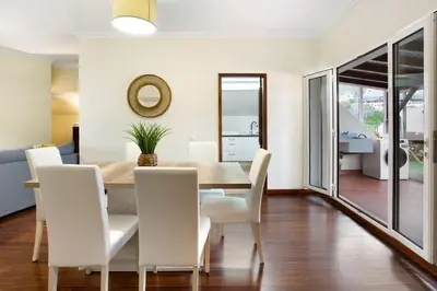 a dining room with a table and white chairs at Penthouse Vista Mar in Funchal