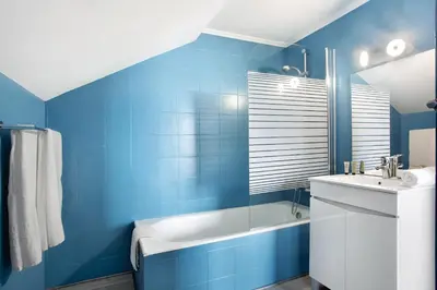 a blue bathroom with a sink and a bath tub at Penthouse Vista Mar in Funchal
