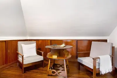 a living room with two chairs and a table at Penthouse Vista Mar in Funchal