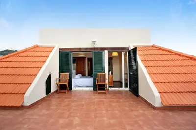 two roofs of a house with a bedroom and a bed at Penthouse Vista Mar in Funchal