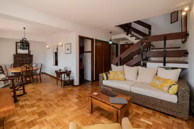 a living room with a couch and a table at Matur I by An Island Apart in Água de Pena
