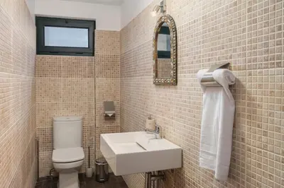 a bathroom with a white toilet and a sink at Matur I by An Island Apart in Água de Pena