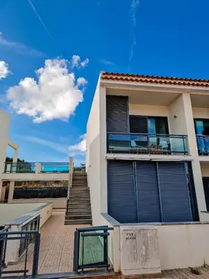 a house with a staircase leading up to a balcony at Villas Horizonte Capazi in Porto Santo