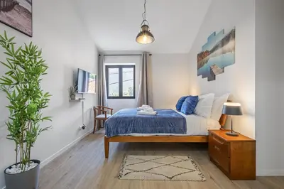 a bedroom with a bed and a potted plant at Basalt Dwelling II by Homie in São Vicente