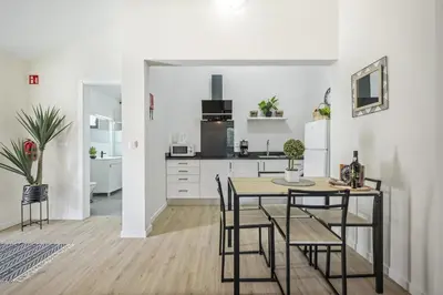 a kitchen and dining room with a table and chairs at Basalt Dwelling II by Homie in São Vicente