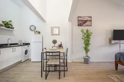 a kitchen and dining room with a table and chairs at Basalt Dwelling II by Homie in São Vicente