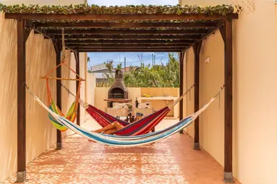 a hammock hanging in a hallway of a house at H2Ome by An Island Apart in Porto Santo