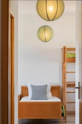 a bedroom with a bed and two lights at H2Ome by An Island Apart in Porto Santo