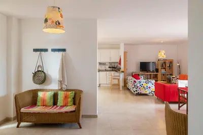 a living room with a couch and a kitchen at H2Ome by An Island Apart in Porto Santo