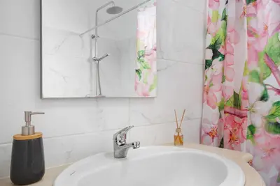 a bathroom with a sink and a mirror at Casa da Ribeira da Janela in Porto Moniz