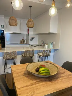 a bowl of fruit on a table in a kitchen at Casa Castanheta in Câmara de Lobos