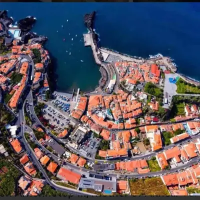 an aerial view of a city next to the water at Casa Castanheta in Câmara de Lobos