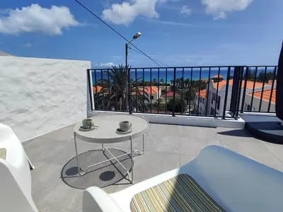 a balcony with a table and a view of the ocean at ALDABRA - CASA VACANZE EM PORTO SANTO in Porto Santo