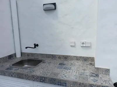 a bathroom with a sink and a tile counter at ALDABRA - CASA VACANZE EM PORTO SANTO in Porto Santo