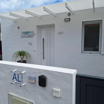 a white house with a sign on the side of it at ALDABRA - CASA VACANZE EM PORTO SANTO in Porto Santo