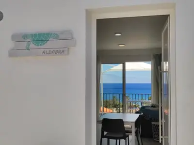 a dining room with a view of the ocean at ALDABRA - CASA VACANZE EM PORTO SANTO in Porto Santo