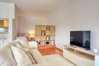a living room with a couch and a flat screen tv at Monumental Tower, a Home in Madeira in Funchal