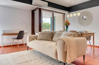 a living room with a couch and a table at Monumental Tower, a Home in Madeira in Funchal