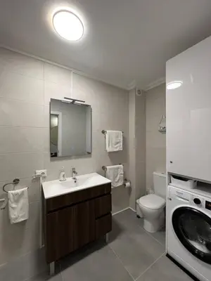 a bathroom with a sink and a washing machine at Retiro do Sossego in Sagres