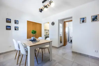 a kitchen and dining room with a table and chairs at Casa Memória in Vila do Bispo